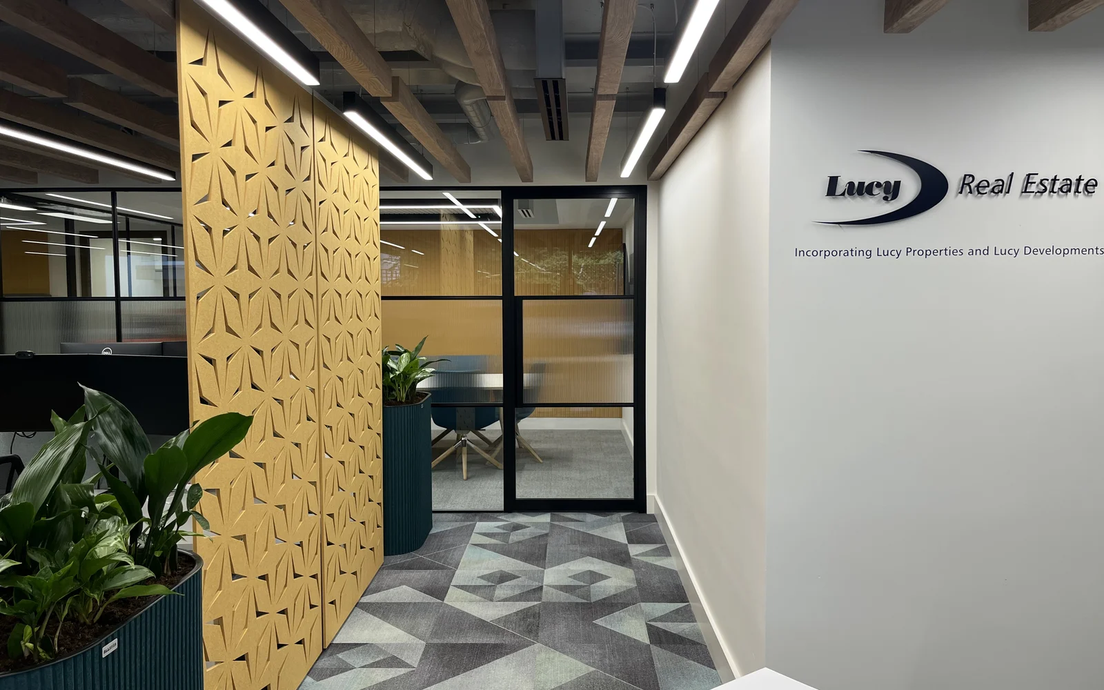 The corridor features white lighting overhead lighting company logo on the wall.