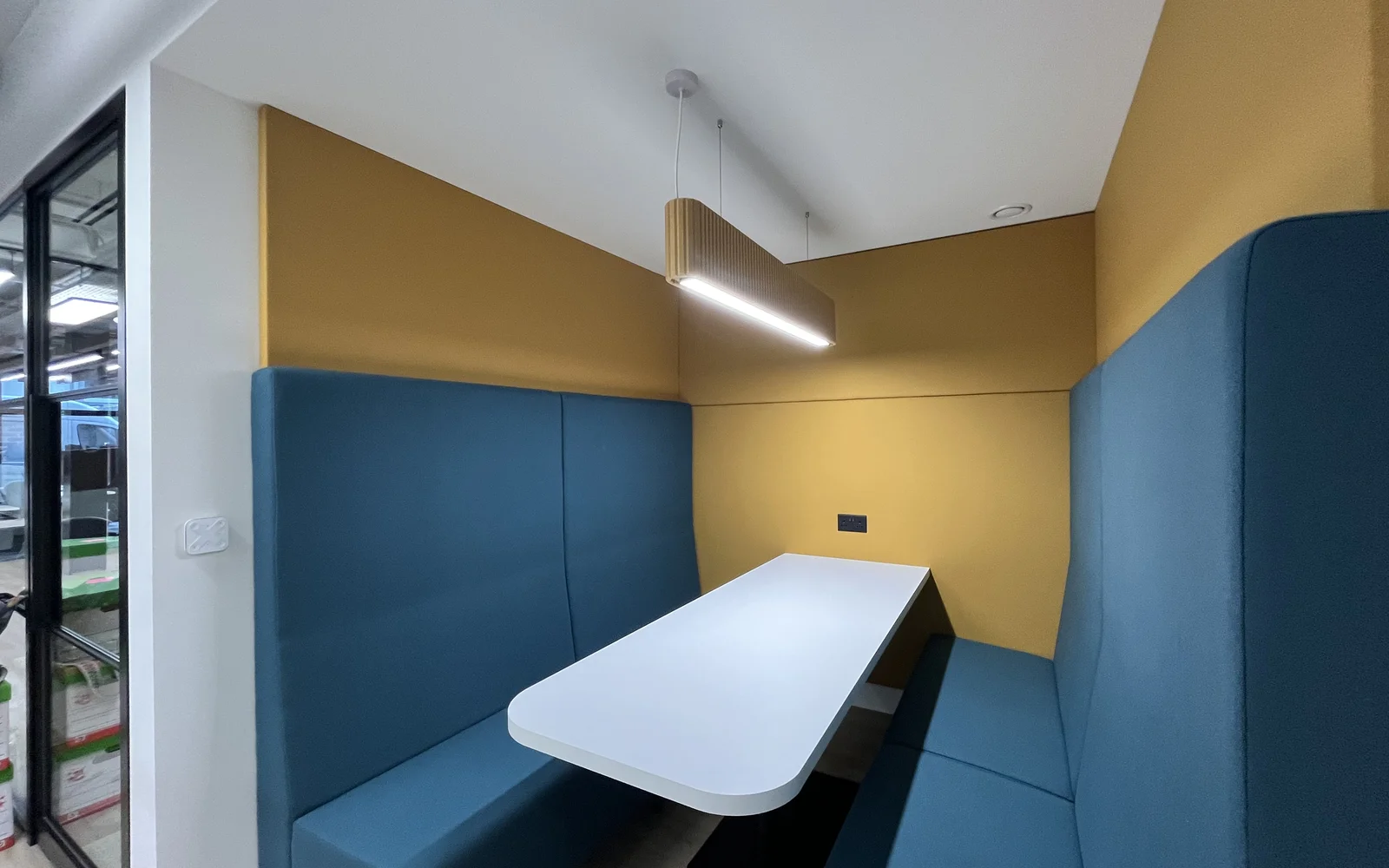 A booth featuring green and yellow colors and lights above