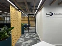The corridor features white lighting overhead lighting company logo on the wall.