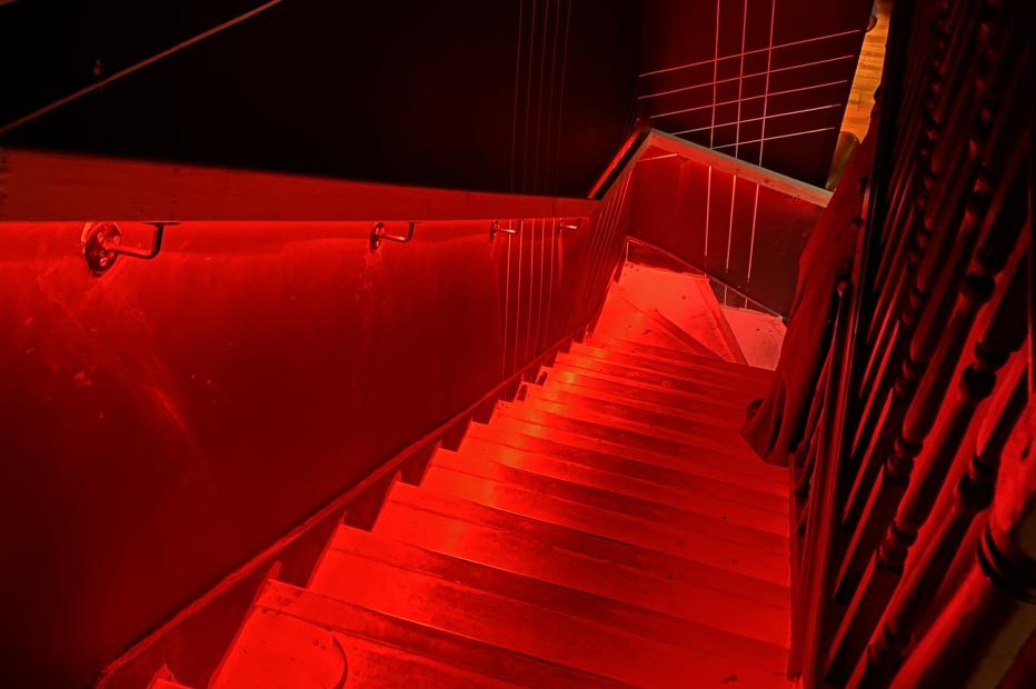 Staircase with red lighting going all the way down 